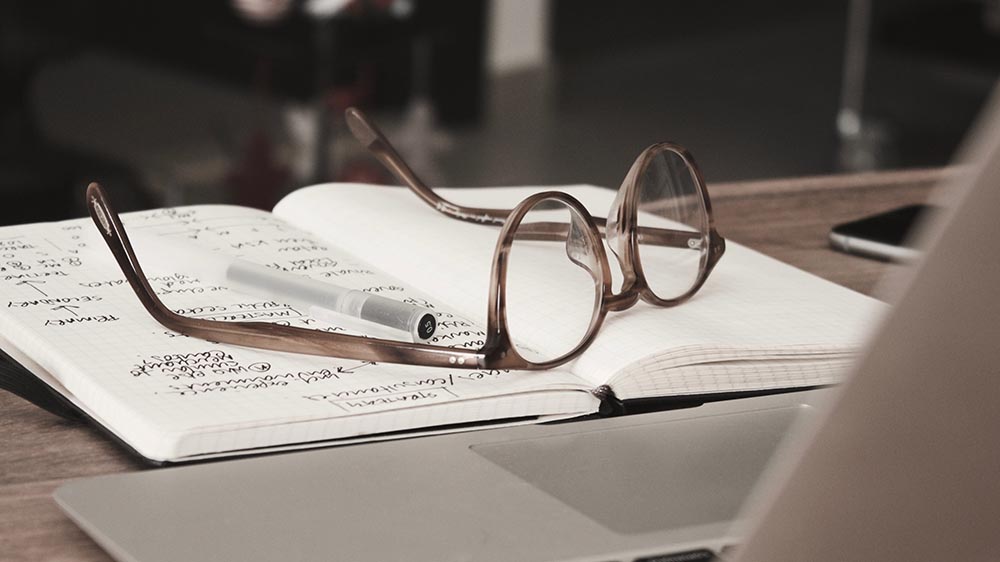 Eye glasses on a lab book. Photo by <a href="https://unsplash.com/@dandimmock?utm_source=unsplash&utm_medium=referral&utm_content=creditCopyText">Dan Dimmock</a> on <a href="https://unsplash.com/s/photos/psychology?utm_source=unsplash&utm_medium=referral&utm_content=creditCopyText">Unsplash</a>   