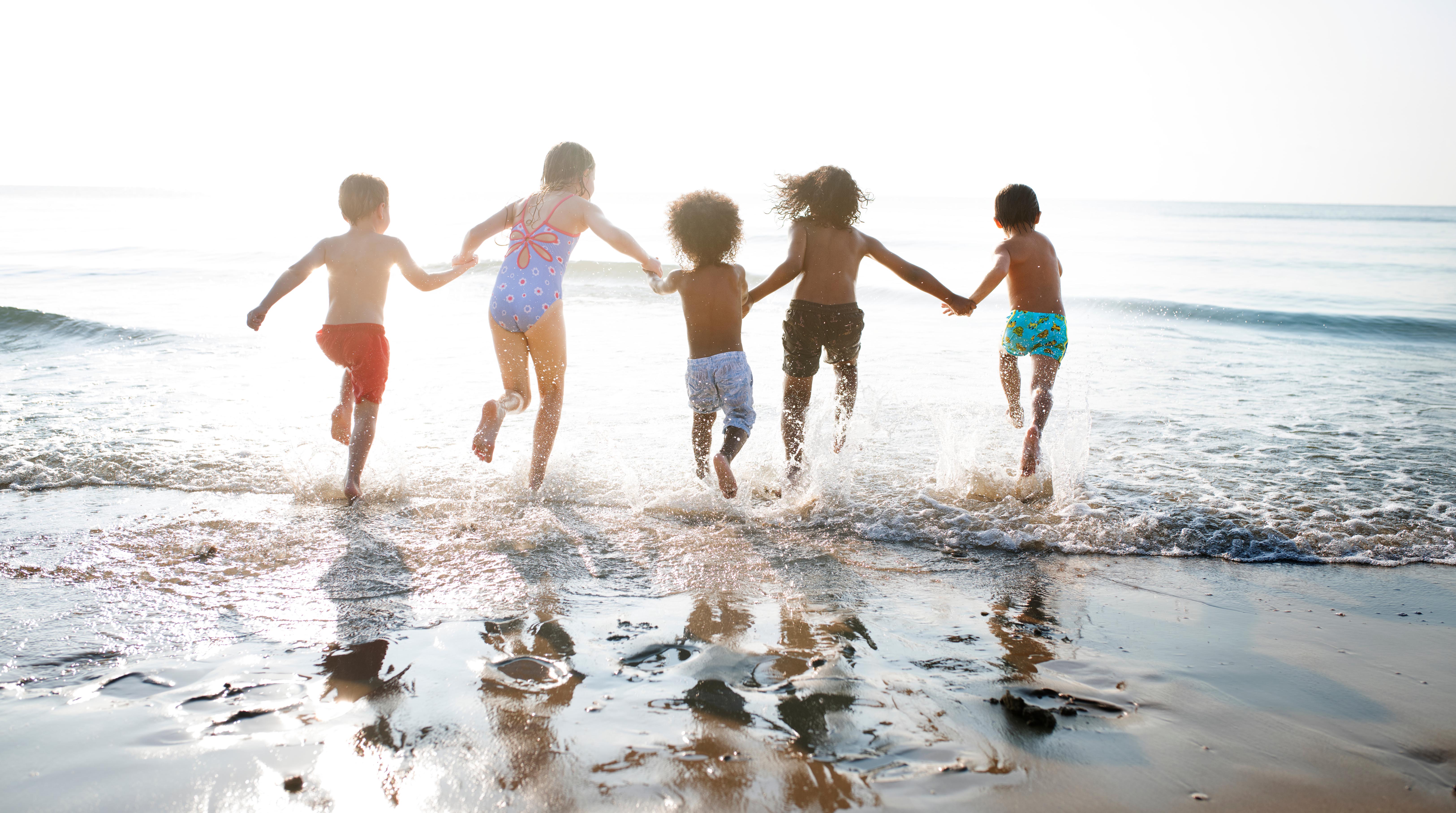 Kids playing in surf at the beach
