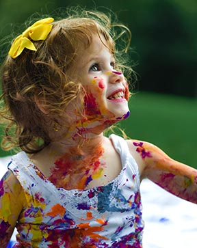 Smiling young girl covered in paint; Photo by <a href="https://unsplash.com/@senjuti?utm_source=unsplash&utm_medium=referral&utm_content=creditCopyText">Senjuti Kundu</a> on <a href="https://unsplash.com/s/photos/education?utm_source=unsplash&utm_medium=referral&utm_content=creditCopyText">Unsplash</a>   